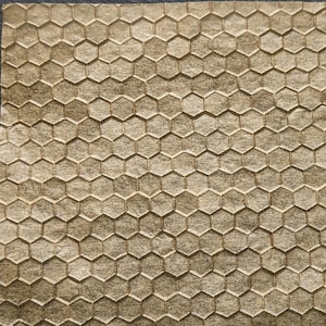 May include: A close-up of a brown textured paper with a honeycomb pattern. The paper is measured with a ruler, showing it is approximately 4 inches wide.