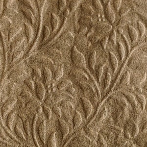 May include: A brown paper napkin with an embossed floral pattern. The pattern features a repeating design of leaves and flowers.