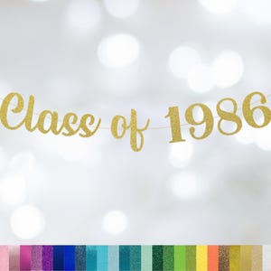 May include: A gold glitter banner that reads "Class of 1986" against a blurred white background. The banner is strung on a thin gold string. A color palette of glitter options is displayed at the bottom.