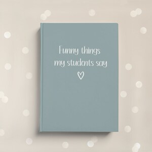 May include: A blue notebook with the text "Funny things my students say" and a small heart symbol.