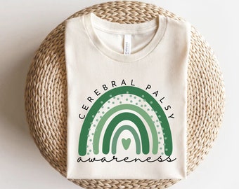 May include: A white t-shirt with a green rainbow design and the text "Cerebral Palsy Awareness".