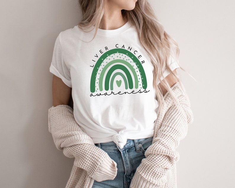 May include: White t-shirt with a green rainbow design and the text "Liver Cancer Awareness".