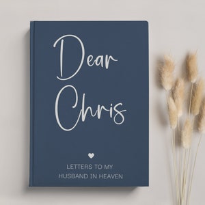 May include: A navy blue journal with the text "Dear Chris" in white script and the words "Letters to my Husband in Heaven" in white text. A small white heart is between the two lines of text.