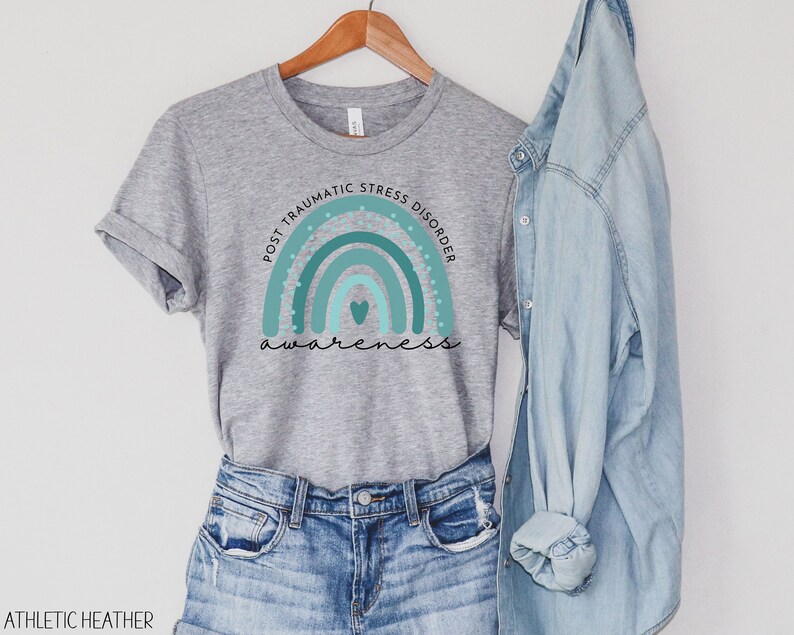 May include: Grey t-shirt with a teal rainbow and the text "Post Traumatic Stress Disorder Awareness".