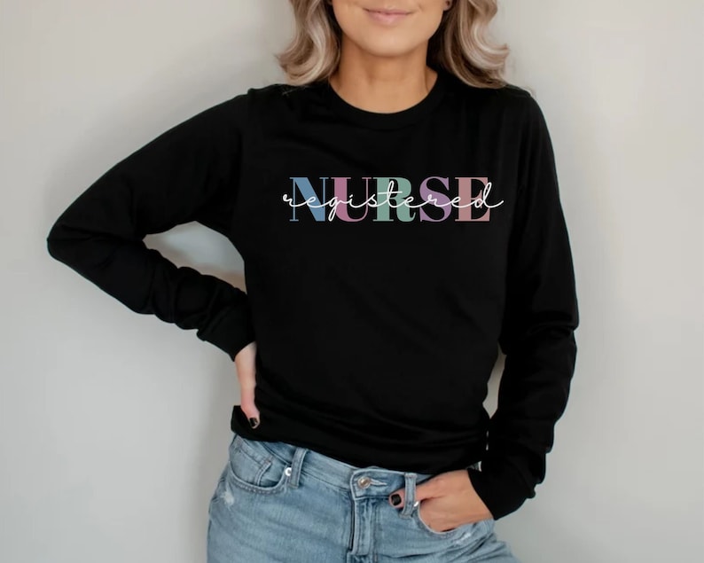 May include: Black long-sleeve shirt with the text "NURSE registered" in colorful letters.