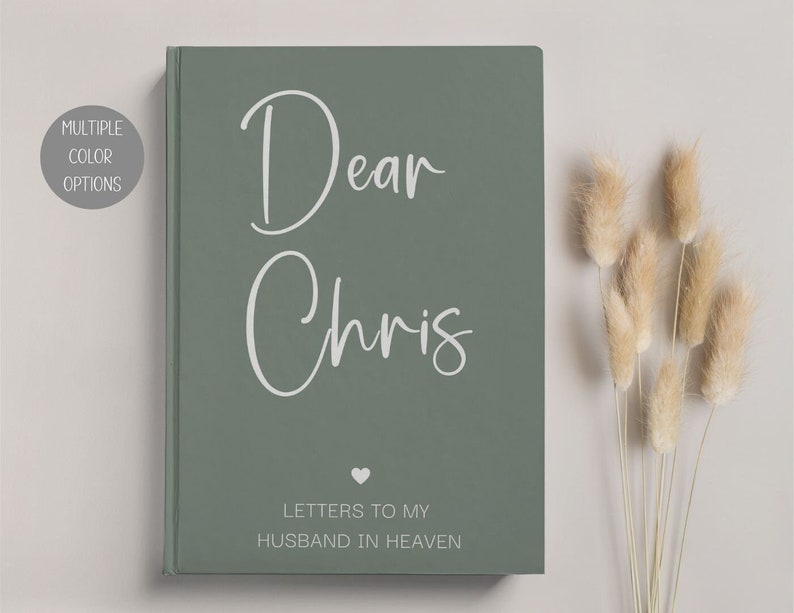 May include: A sage green journal with the text "Dear Chris" in white script. The journal has a small heart symbol and the text "Letters to my Husband in Heaven" in white.