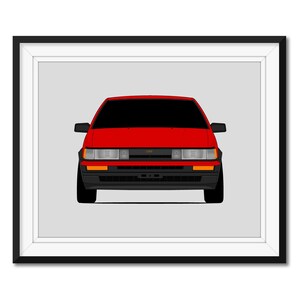 以下が含まれることがあります： 赤いトヨタ・カローラAE86の額装されたイラスト。クラシックな日本のスポーツカー。車は正面を向いており、ヘッドライトとグリルが見える