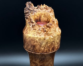 May include: A wooden box with a unique, natural burl wood finish. The lid is shaped like a mountain with a small, round opening in the top. The box is approximately 6 inches tall.