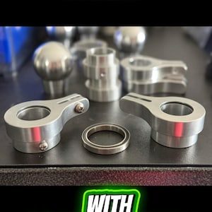 May include: Machined solid aluminum flagrings with industrial grade sealed bearings. The image shows several silver-colored metal parts, including rings and brackets. The text in the image highlights the materials and features of the product.