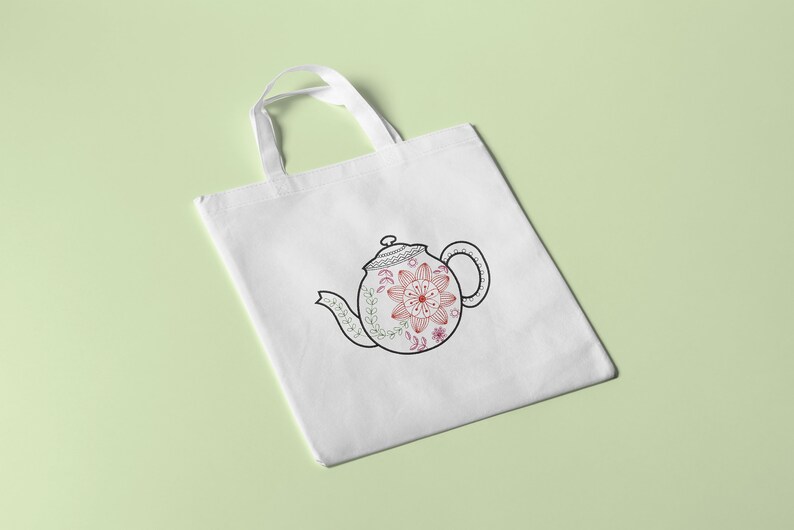 May include: White tote bag featuring a black and white outline of a teapot with a floral design. The teapot is decorated with pink and red flowers.