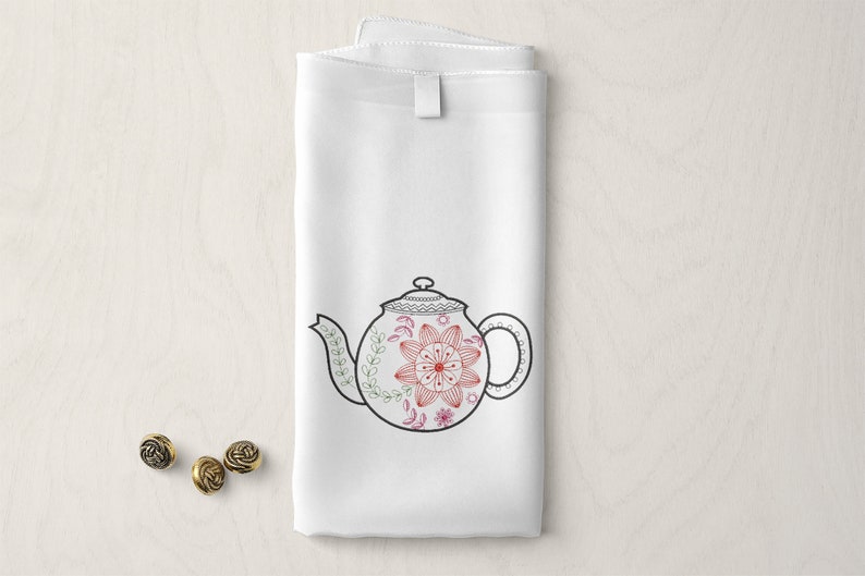 May include: White tea towel with a black and red embroidered teapot design. The teapot has a floral pattern with a red centre.