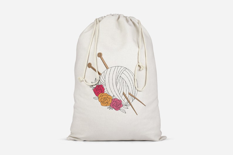 May include: A white drawstring bag with a design of a ball of yarn, knitting needles, and flowers. The flowers are red, orange, and pink.