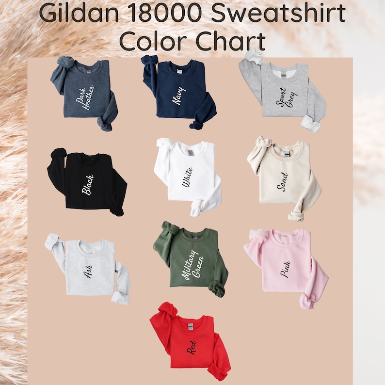 May include: Color chart for Gildan 18000 sweatshirts. The chart shows 10 different colors: Ash, Black, Dark Heather, Military Green, Navy, Pink, Red, Sand, Sport Grey, and White.