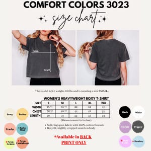 Peut inclure: Un tableau des tailles pour t-shirt boxy &eacute;pais Comfort Colors 3023 montrant des vues avant et arri&egrave;re d'un t-shirt gris anthracite. Inclut un tableau avec les mesures de largeur, poitrine et longueur en pouces pour les tailles S &agrave; 2XL et douze pastilles de couleur.