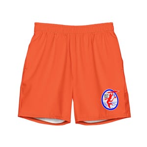 May include: Bright orange athletic shorts with an elastic waistband and side pockets. A circular logo on the lower right features a red devil fish, a blue wave, and the text "devil fish".