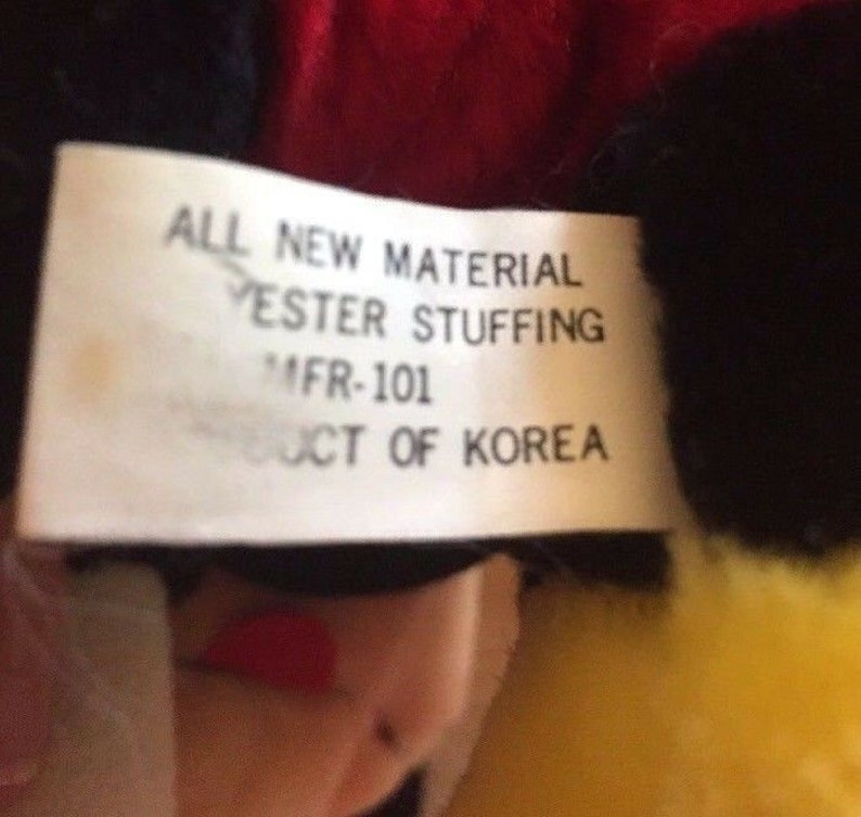 May include: A white tag with black text that reads "ALL NEW MATERIAL YESTER STUFFING MFR-101 PRODUCT OF KOREA".