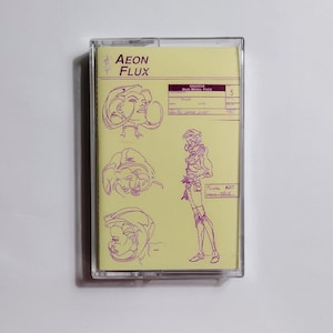 May include: A yellow cassette tape with purple line art of a woman's face and body. The text "AEON FLUX" is printed on the tape. The text "CR42208 MAIN MODEL PACK" is printed on the tape. The number "5" is written on the tape.