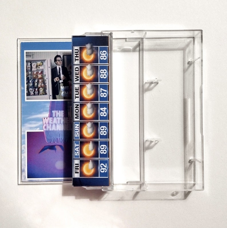 May include: A blue and yellow cassette tape with a weather forecast for the week. The forecast includes daily high temperatures and a sun icon with clouds. The text on the tape reads "FRI SAT SUN MON TUE WED THU" and "92 89 89 84 87 88 86".