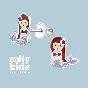 May include: Sterling silver mermaid stud earrings with purple and brown enamel and glitter accents. The earrings are marked 925.