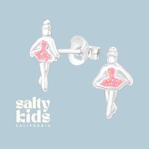 May include: Sterling silver ballerina stud earrings with pink glitter detailing. The earrings are small and delicate, perfect for a young girl.