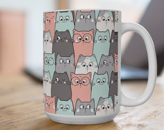 May include: White ceramic mug with a pattern of colorful cartoon cats. The cats are in various poses and have different expressions. The mug has a large handle.