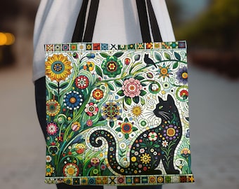 Könnte beinhalten: Eine schwarze Tragetasche mit einem bunten Blumenmuster und einer schwarzen Katzensilhouette. Die Blumen sind in Rot-, Gelb-, Grün-, Blau- und Lilatönen gehalten. Die Katze sitzt in der Mitte der Tasche und blickt nach rechts.