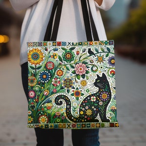 May include: A black tote bag with a colorful floral pattern and a black cat silhouette. The flowers are in shades of red, yellow, green, blue, and purple. The cat is sitting in the center of the bag, looking to the right.