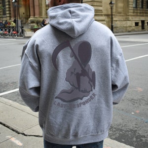 K&ouml;nnte beinhalten: Ein grauer Kapuzenpullover mit einem Grafikdruck einer Kapuzenfigur, die eine Sense h&auml;lt. Der Text "Last Responder" ist unter dem Grafikdruck aufgedruckt.