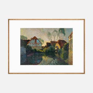 Post-impressionist style painting of a quaint village with colorful houses along a waterway, presented in a light wooden frame with white matting.