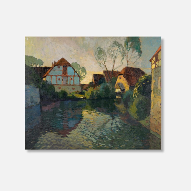 Unframed art print showing a charming riverside village scene with traditional architecture, displayed as a canvas print with visible texture.