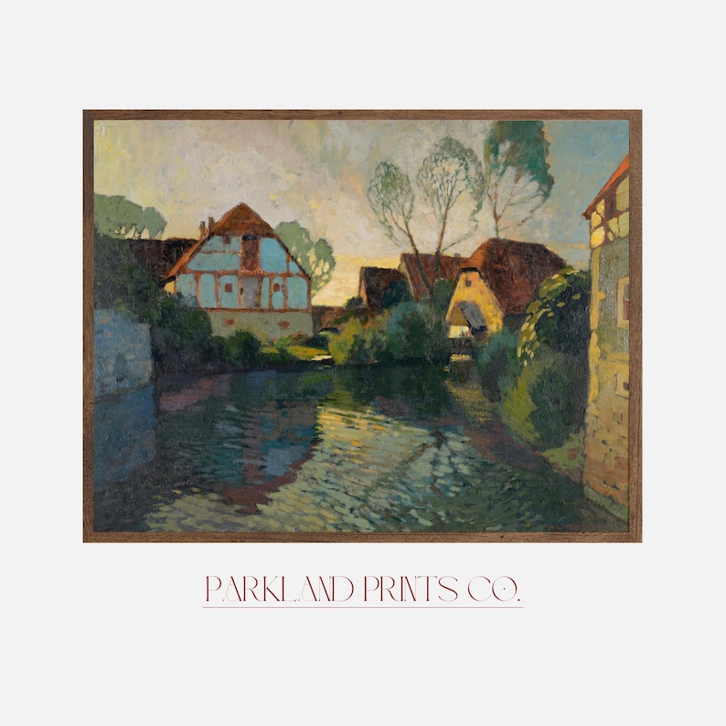 European village scene art print featuring half-timbered houses by a river, displayed in a dark wooden frame against a light background with Parkland Prints Co. branding.