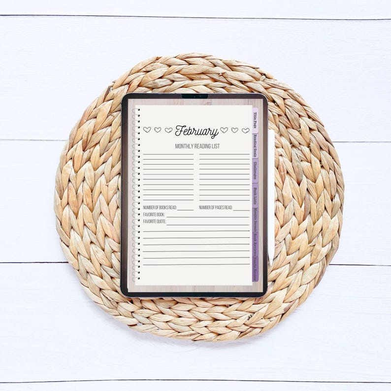 May include: A digital tablet displaying a February reading list template. The template has a light brown background with a white border and includes space to track the number of books and pages read, favorite book, and favorite quote.