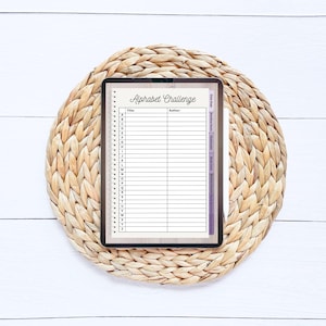 May include: A digital tablet displaying a printable alphabet challenge list. The list includes spaces for the title, author, and book titles for each letter of the alphabet.