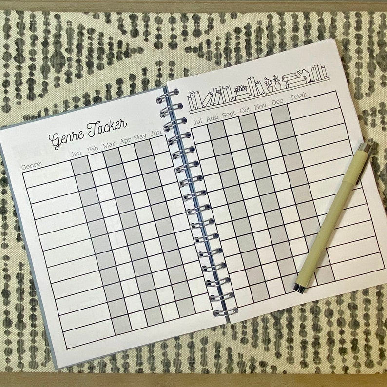 May include: A black and white book tracker with a grid for logging books read by genre and month. The cover features a row of books with the text "Genre Tracker" at the top.