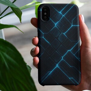 May include: Black smartphone case with a geometric design of interconnected blue lines. The case has a matte finish and a camera cutout. The phone case is held in a hand near green leaves.