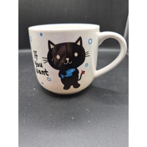 May include: A set of three ceramic mugs with a speckled, matte finish. The mugs are in shades of cream, light gray, and dark gray. Each mug has a simple, minimalist design, perfect for coffee or tea.