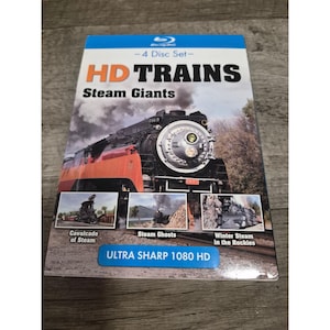May include: A Blu-ray 4 disc set titled HD TRAINS Steam Giants. The cover features a large black steam locomotive, three smaller inset photos labeled Cavalcade of Steam, Steam Ghosts, and Winter Steam in the Rockies, and text stating ULTRA SHARP 1080 HD.