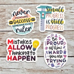 May include: Four die-cut stickers with motivational text. One reads 'never measure your success with someone else's ruler', another 'Small progress is still progress' with a caliper, 'MATH Mistakes ALLOW thinking to HAPPEN' with a lightbulb, and 'Be PROUD of how HARD you are TRYING' with various school icons.