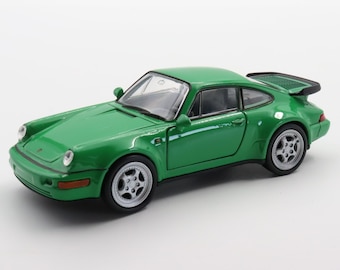 May include: A green 1:18 scale model of a Porsche 911 Turbo.