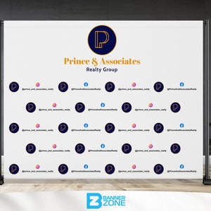 May include: White backdrop with a gold and blue logo that says "Prince & Associates Realty Group". The backdrop is covered in a repeating pattern of the logo and the text "@prince_and_associates_realty".