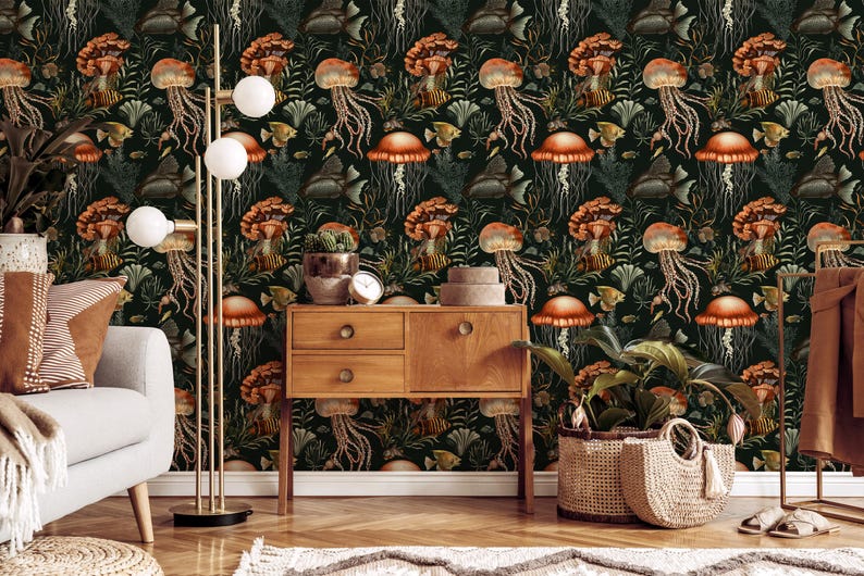 May include: A dark green wallpaper with a repeating pattern of orange jellyfish, mushrooms, and fish. A wooden cabinet, floor lamp, and potted plants are in front of the wallpaper. The room is decorated in a natural, botanical theme.