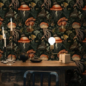 May include: Dark wallpaper featuring a repeating pattern of jellyfish, fish, and coral in shades of orange, brown, and green against a black background. A wooden table with candles and a light fixture is in the foreground.