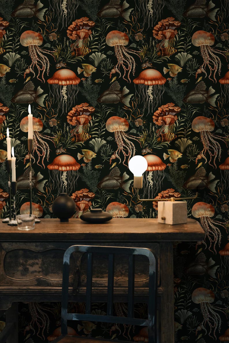 May include: Dark wallpaper featuring a repeating pattern of jellyfish, fish, and coral in shades of orange, brown, and green against a black background. A wooden table with candles and a light fixture is in the foreground.