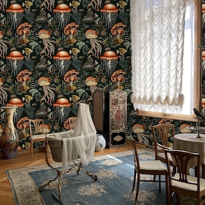 May include: A room with a dark green wallpaper featuring a repeating pattern of jellyfish, fish, and coral. A baby cradle with a white veil sits on a blue floral rug. Wooden chairs and a table are arranged in the room, with a large window and white curtains.