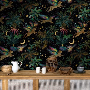 May include: A black wallpaper with a repeating pattern of gold stars, crescent moons, palm trees, and leopards with rainbow wings. The wallpaper is displayed on a wooden shelf with a white jug, two white mugs, a wicker basket, and a metal wire basket.