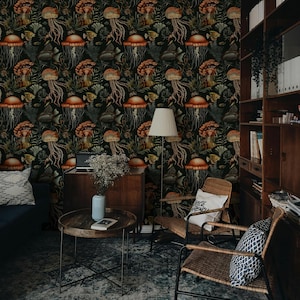 May include: A room with dark wallpaper featuring a repeating pattern of jellyfish, fish, and seaweed in shades of orange, brown, and green. The room includes a blue sofa, wooden furniture, and a round coffee table.