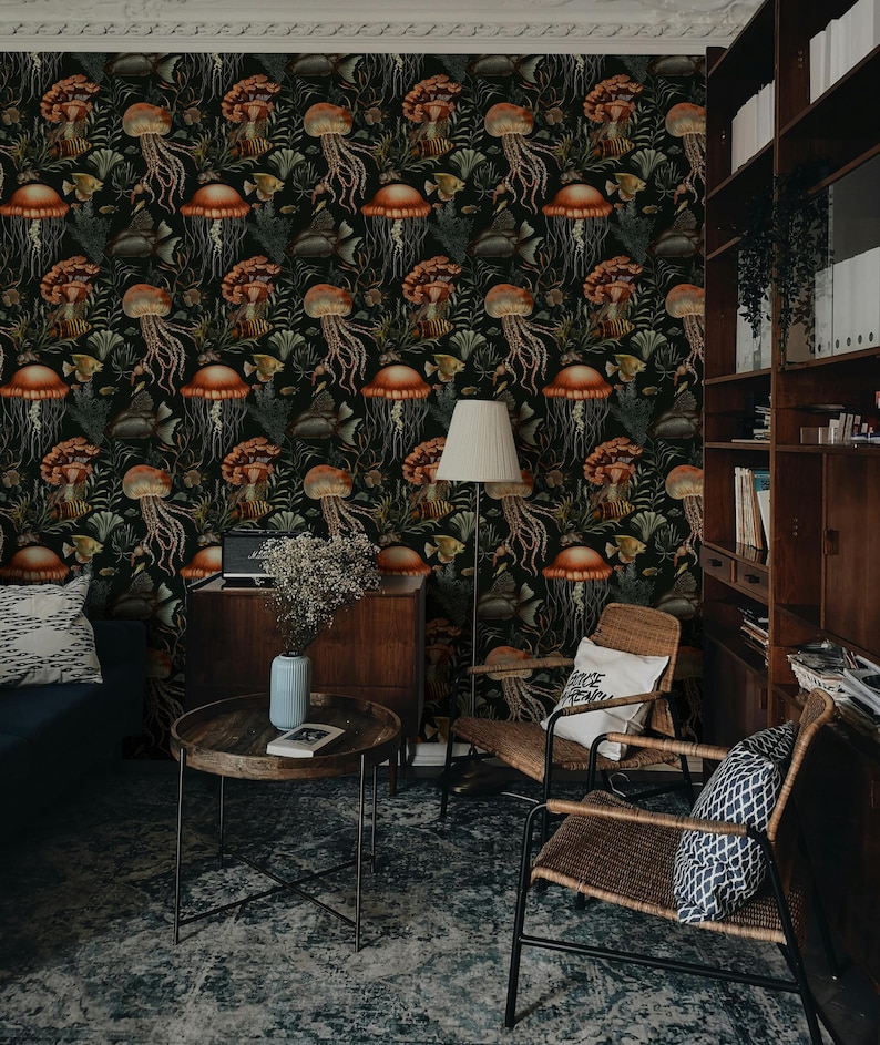 May include: A room with dark wallpaper featuring a repeating pattern of jellyfish, fish, and seaweed in shades of orange, brown, and green. The room includes a blue sofa, wooden furniture, and a round coffee table.