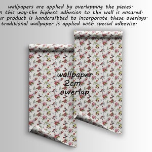 May include: Two rolls of floral wallpaper with a white background and red, pink, and green flowers. The text "wallpaper 2cm overlap" is printed on the rolls.