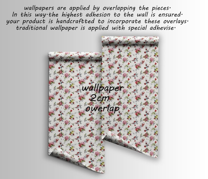 May include: Two rolls of floral wallpaper with a white background and red, pink, and green flowers. The text "wallpaper 2cm overlap" is printed on the rolls.