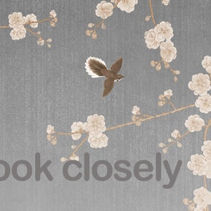 May include: A gray background with a delicate pattern of white flowers and branches. The text "look closely" is printed in the center of the image. A small brown bird with a long tail is flying in the upper left corner.